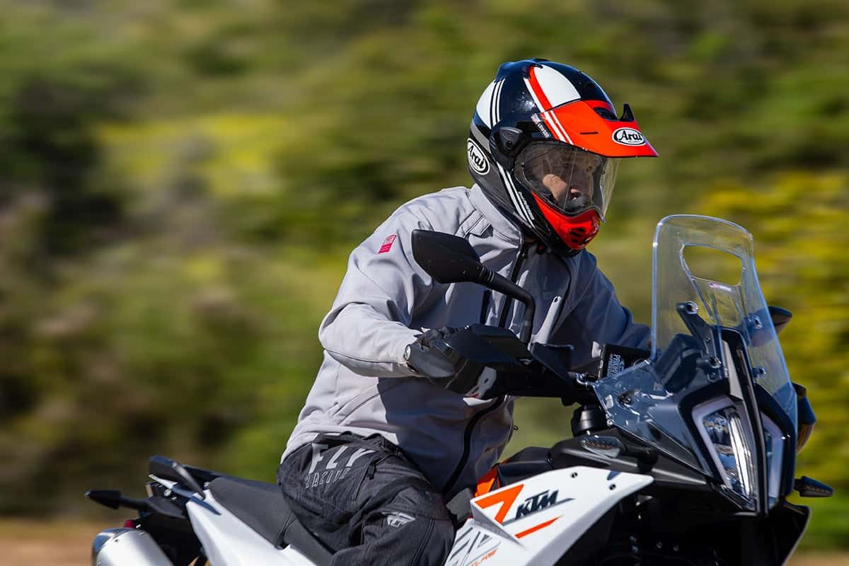 Rider wearing Arai XD-5 helmet on a KTM adventure motorcycle