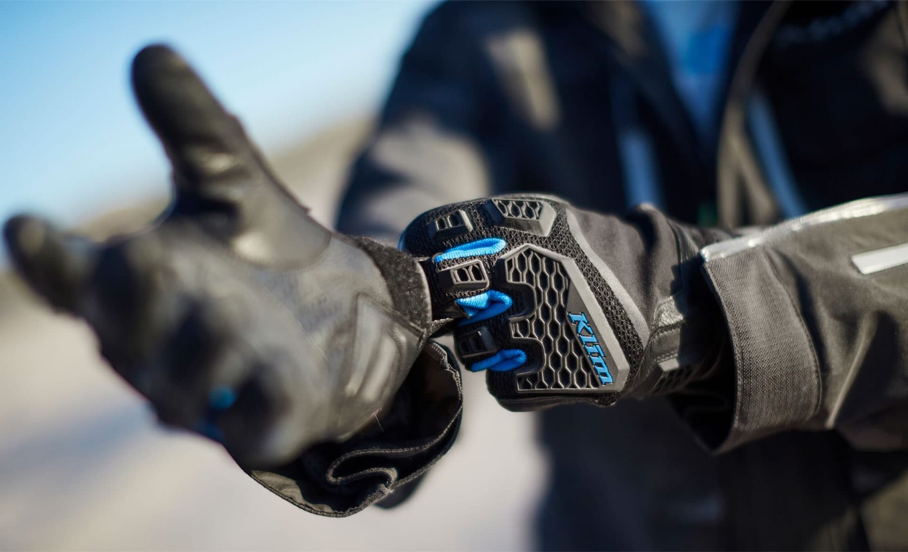Close-up of rider wearing Klim Baja S4 gloves with breathable knuckle armor