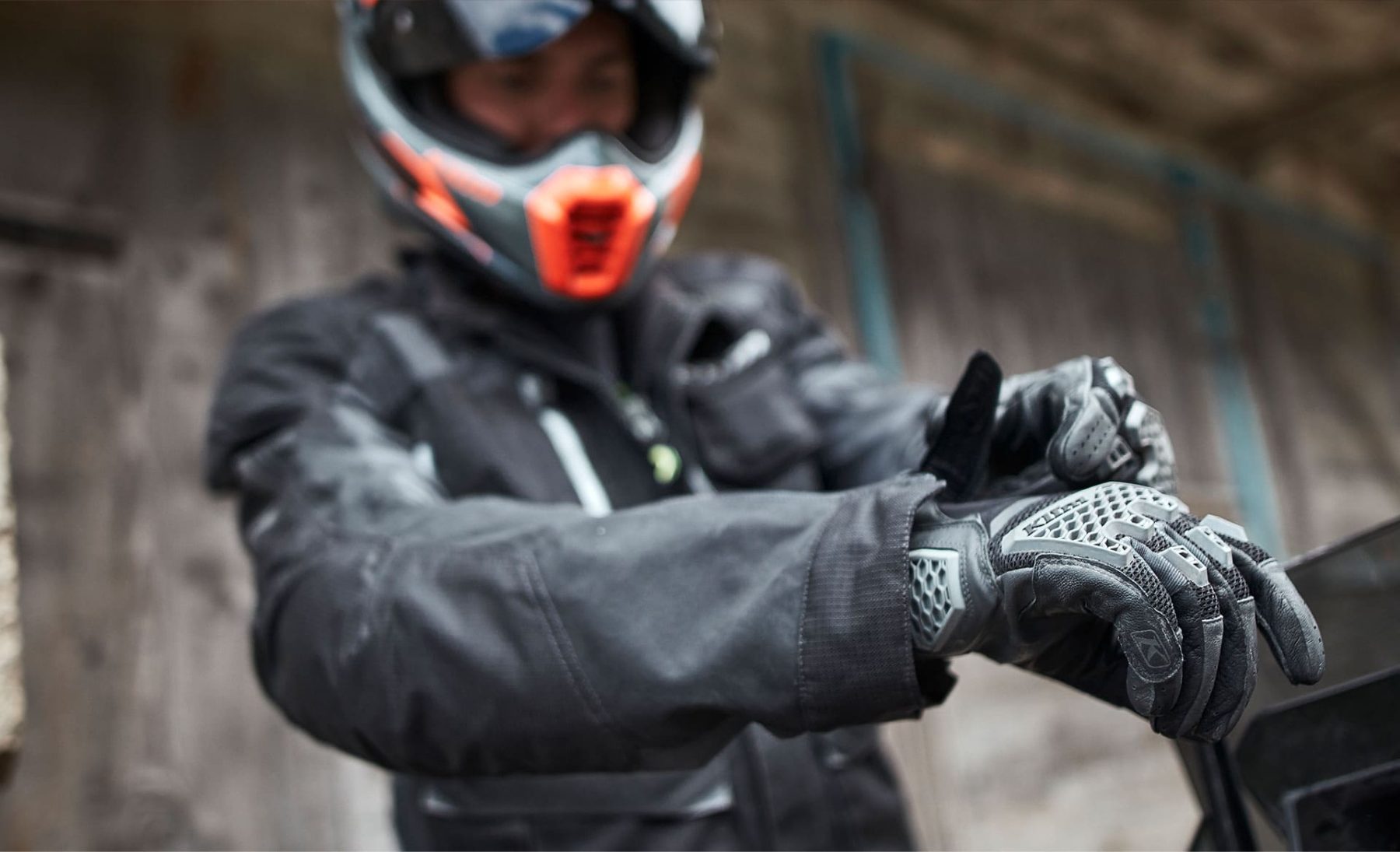 Rider fastening Klim Baja S4 gloves designed for hot, dry conditions