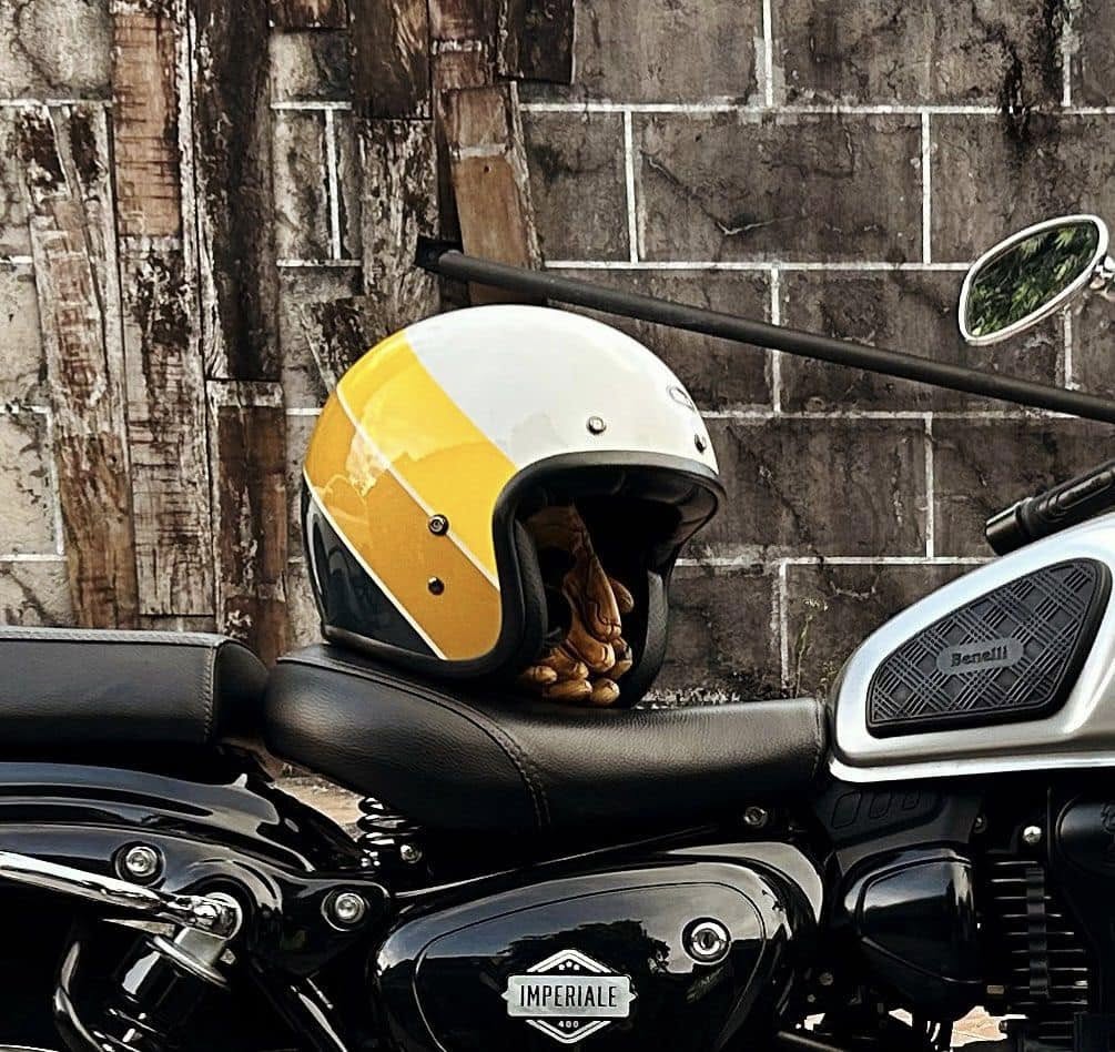 Bell Custom 500 open-face motorcycle helmet resting on a retro-style cruiser motorcycle seat
