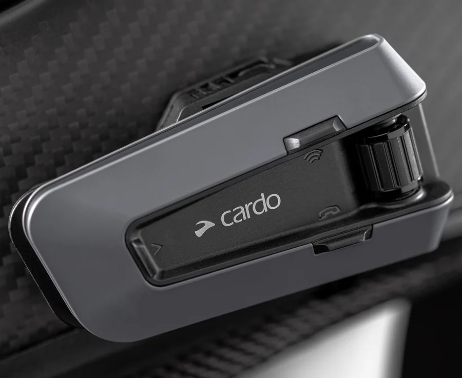 Cardo Packtalk Edge intercom mounted on a motorcycle helmet close-up