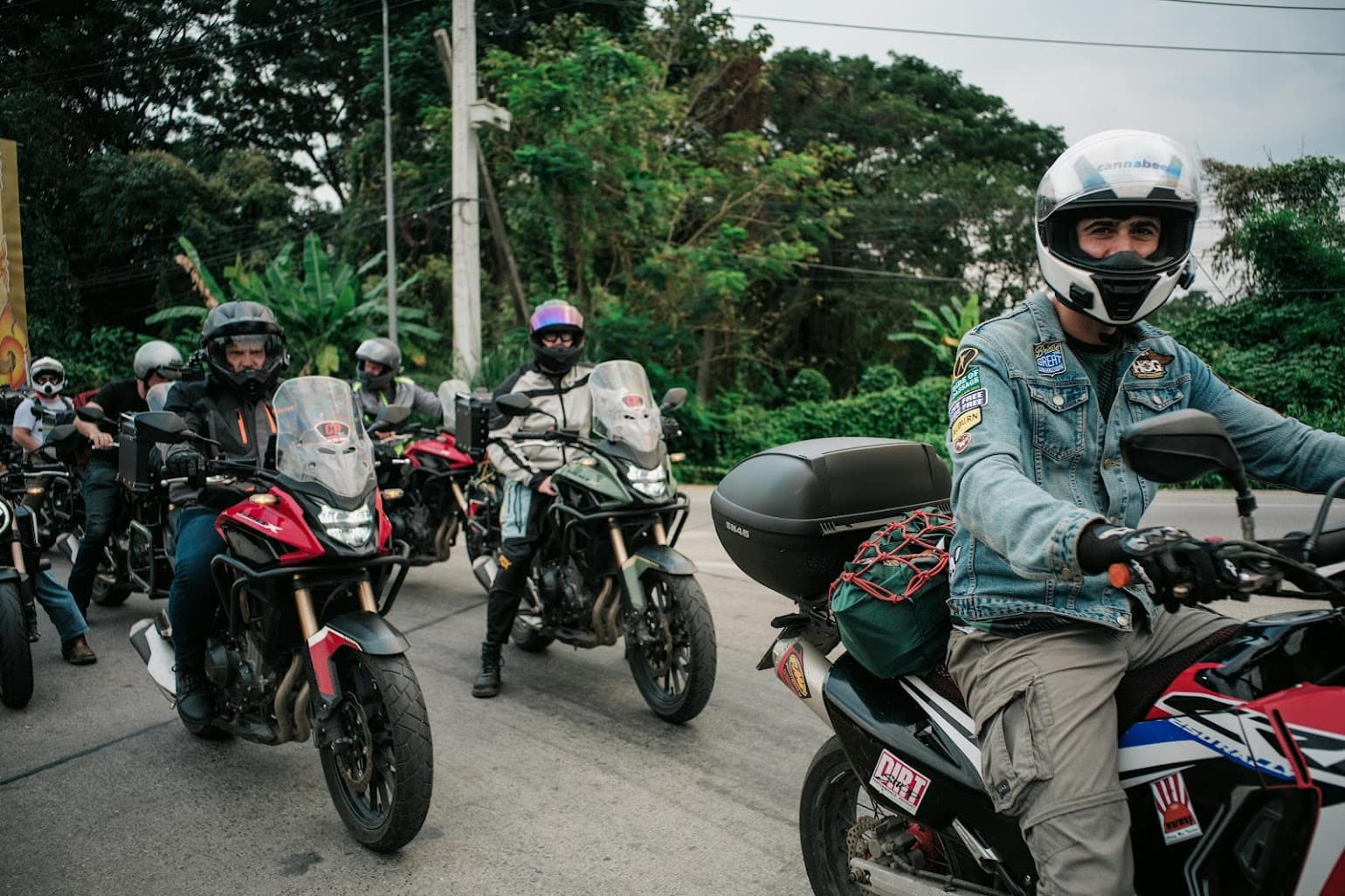 Group of adventure riders preparing to tour on fully loaded motorcycles