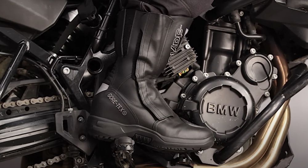 Daytona Lady Star GTX women’s motorcycle boots in black leather with GORE-TEX lining, shown on a rider mounted on a BMW bike.