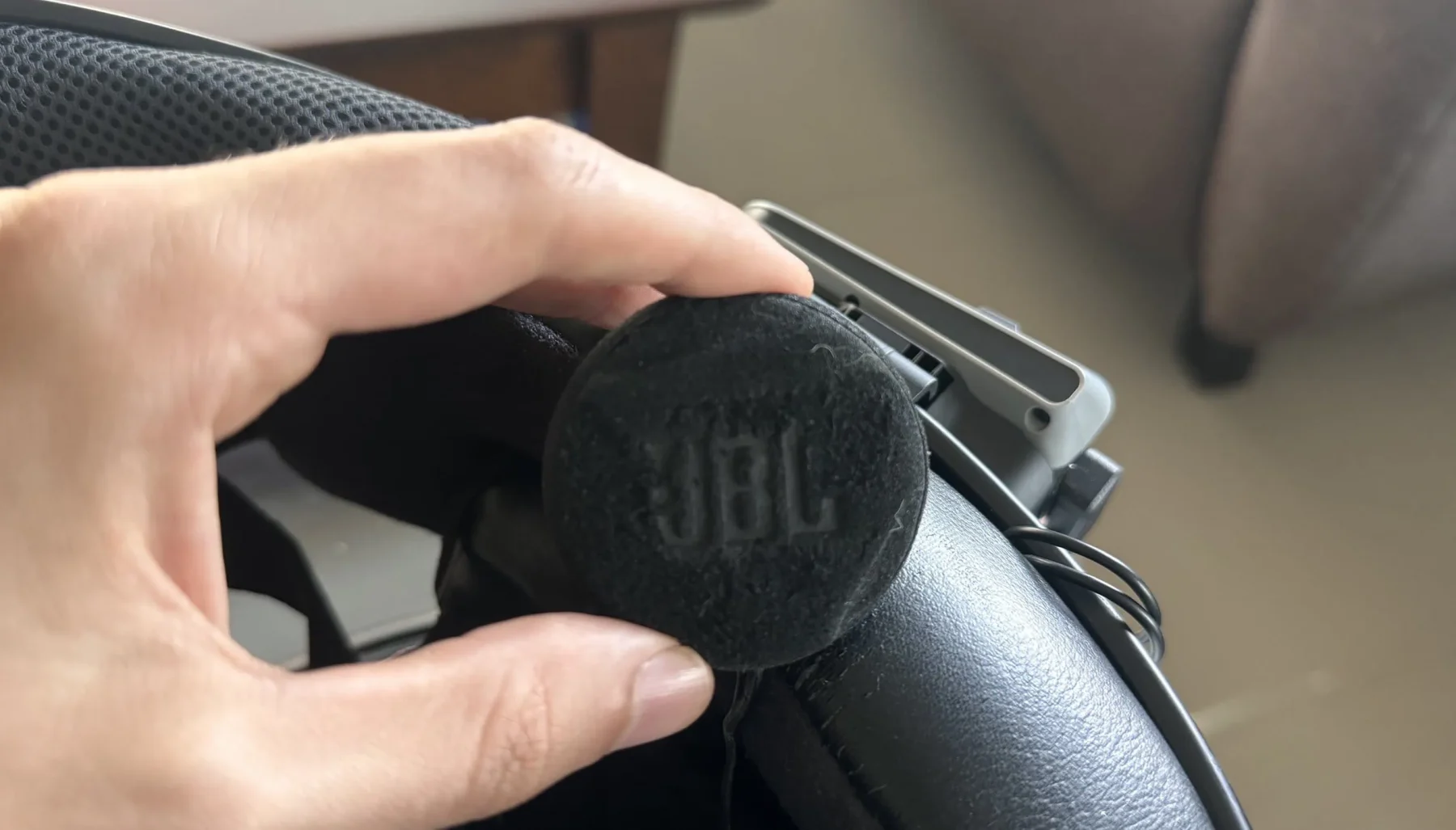 Close-up of a JBL helmet speaker being installed inside a motorcycle helmet