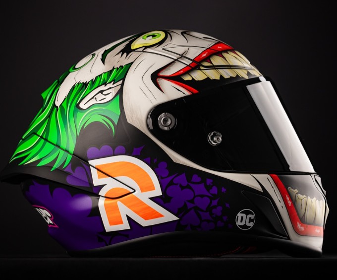 Side view of the HJC RPHA 1N Joker motorcycle helmet featuring vibrant green, purple, and red Joker artwork with a black face shield.