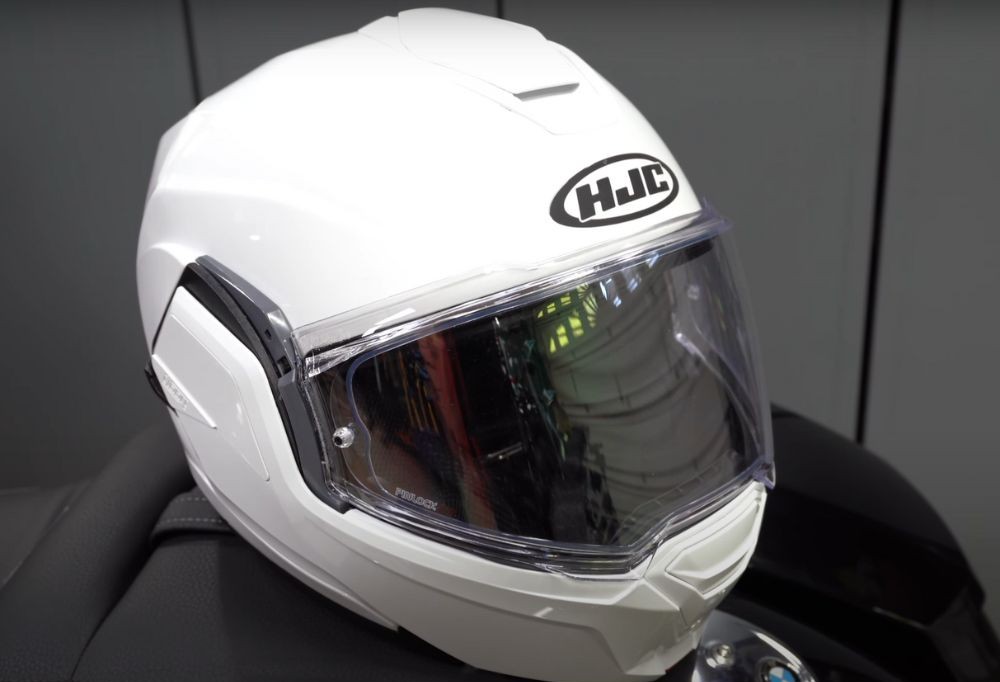 White HJC i100 helmet with Pinlock visor on display