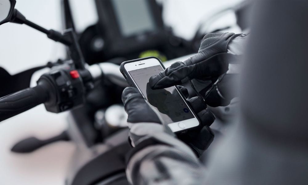Motorcyclist using smartphone GPS with touchscreen-compatible gloves