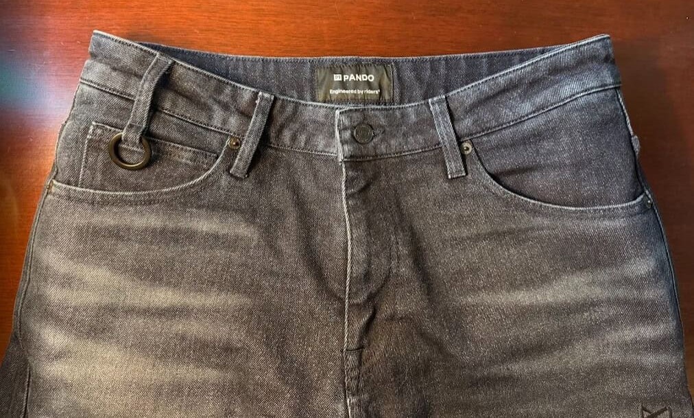 Top-down view of Pando Moto Arnie Slim jeans showing waistband, pockets, and metal loop