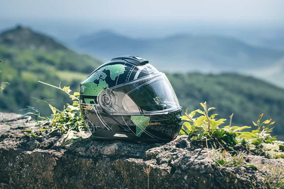 Schuberth C5 modular helmet resting on a scenic mountain overlook