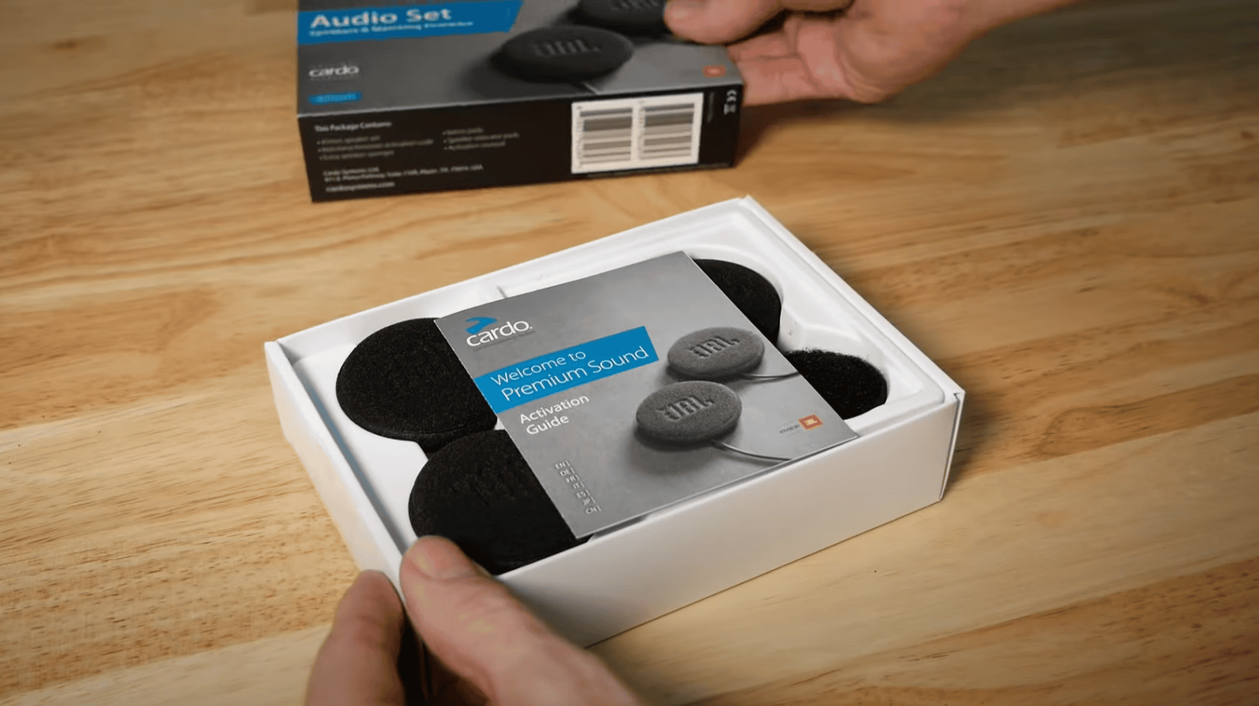 Cardo and JBL 45 mm audio kit with activation guide and foam speakers in retail packaging