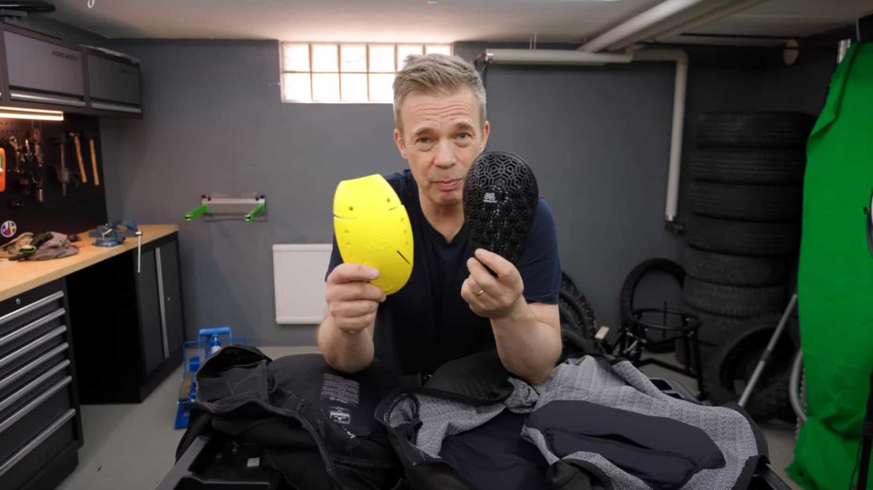 Side-by-side comparison of Knox classic armor pad and Supershirt 2.0 vented pad held by reviewer