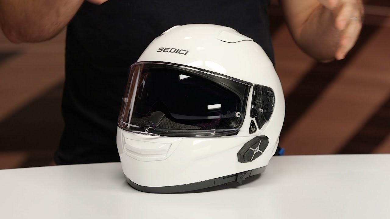 Close-up of white Sedici Sistema 3 Parlare modular helmet with built-in Bluetooth system