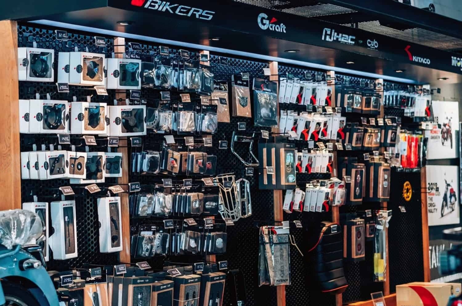 Wall display of various motorcycle parts and accessories in a retail store