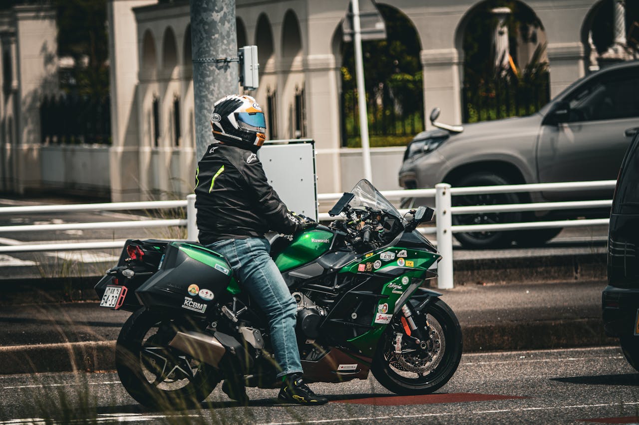Motorcyclist in urban traffic wearing full-face helmet, alert and focused