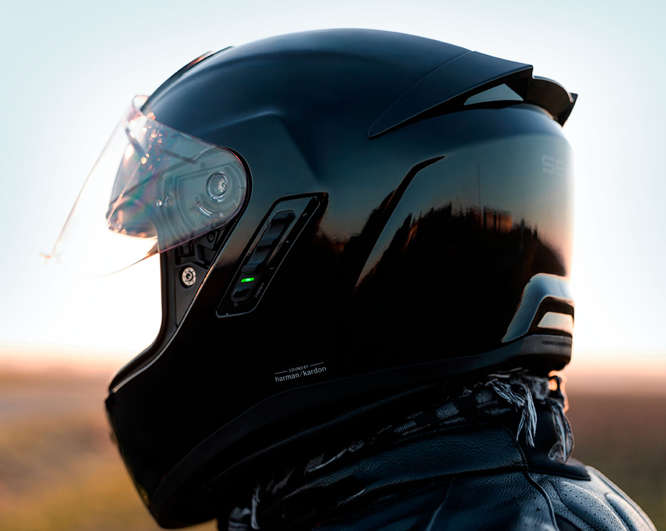Side view of a rider wearing a black Sena Phantom helmet with integrated comms