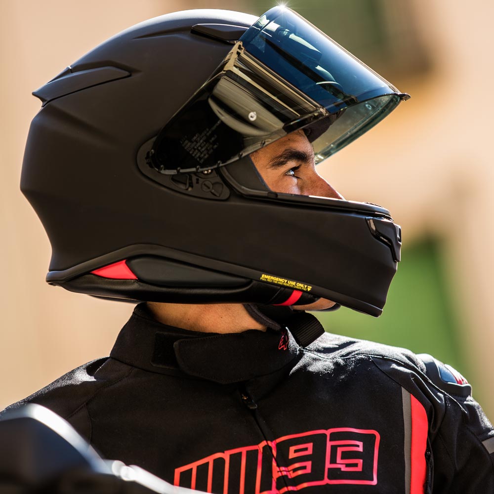 Shoei NXR2 helmet worn by rider, viewed from side, matte black finish