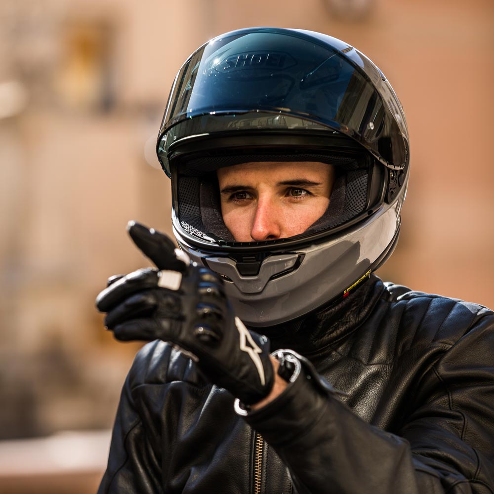 Shoei NXR2 full-face motorcycle helmet worn by rider in leather gear