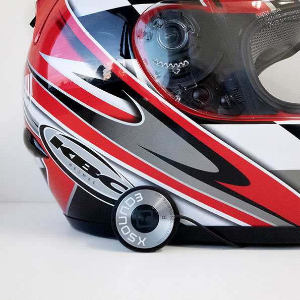 IASUS XSound 4 helmet speaker mounted beside a full-face helmet