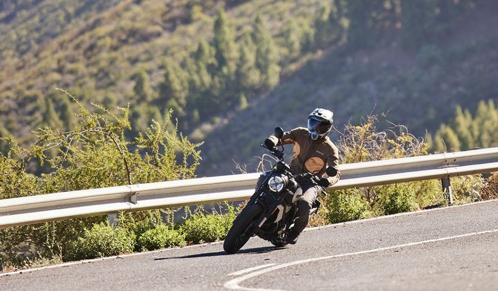 Rider cornering in Klim Marrakesh jacket, showing flexible stretch fabric that moves naturally on the bike.