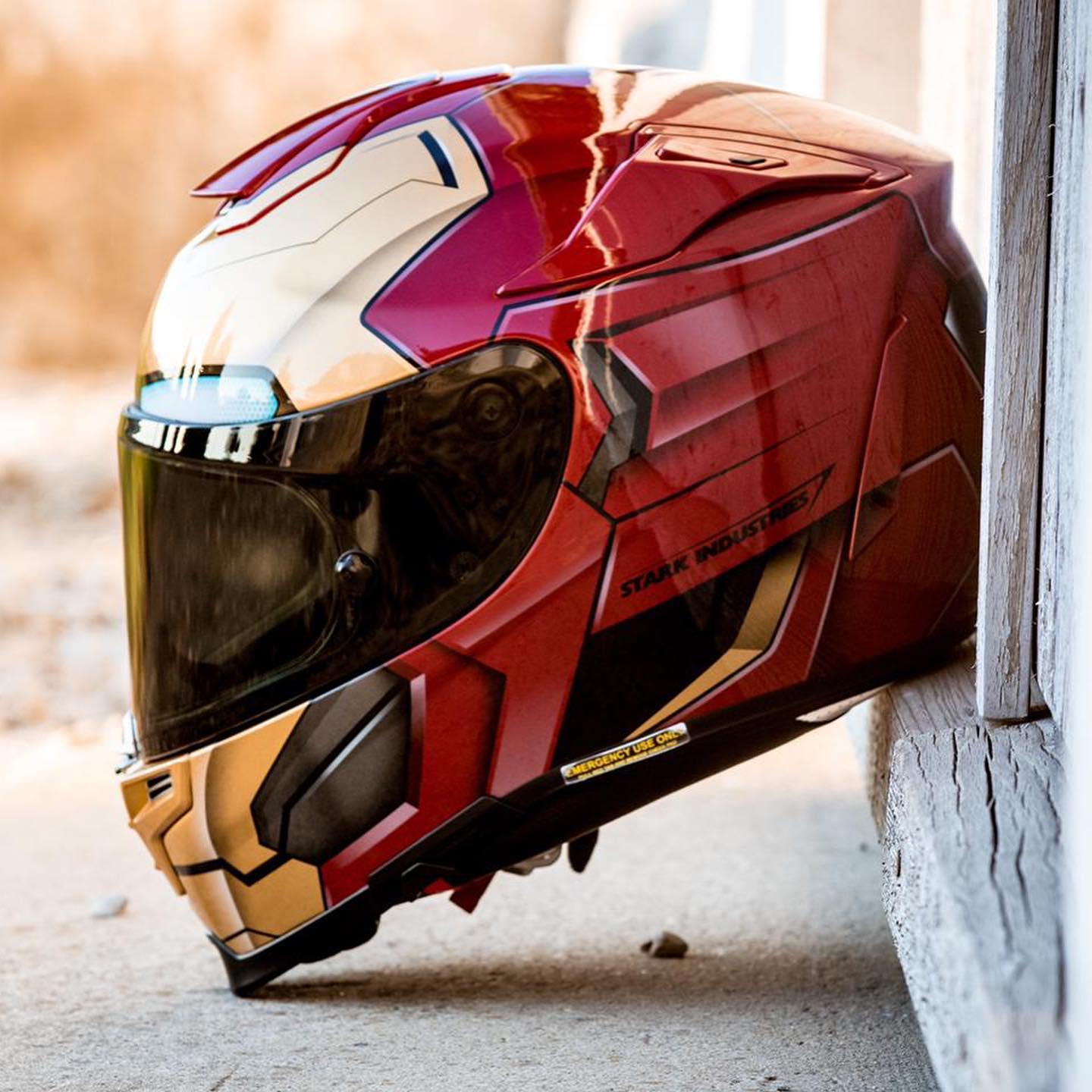 HJC RPHA 70 ST Iron Man motorcycle helmet in red and gold with Stark Industries design.