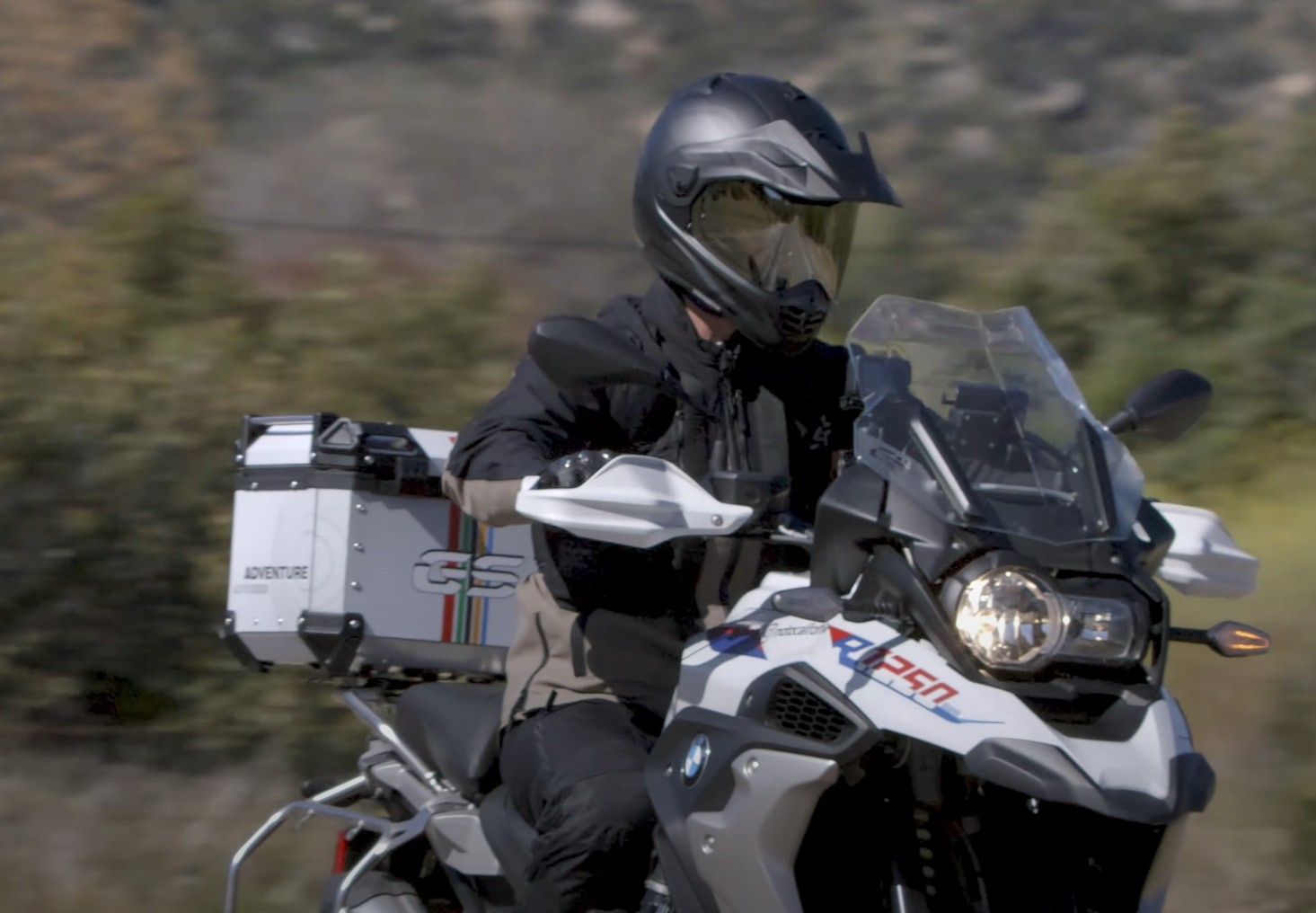 Rider wearing an Arai XD-5 adventure helmet on a BMW GS during a road test