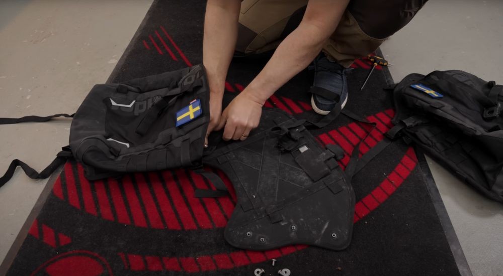 Rider assembling the Lone Rider ADV base plate on a garage mat.