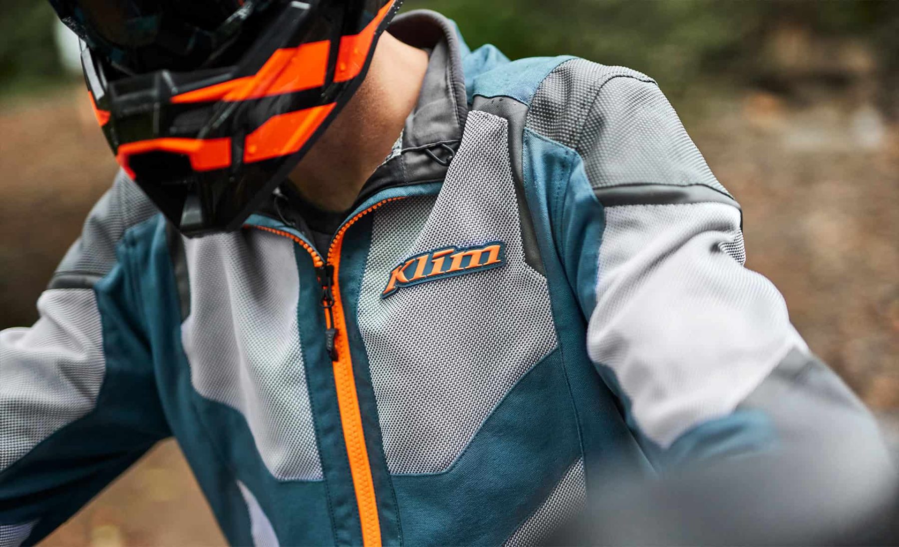 Close-up of Klim Baja S4 mesh jacket with orange zipper and logo