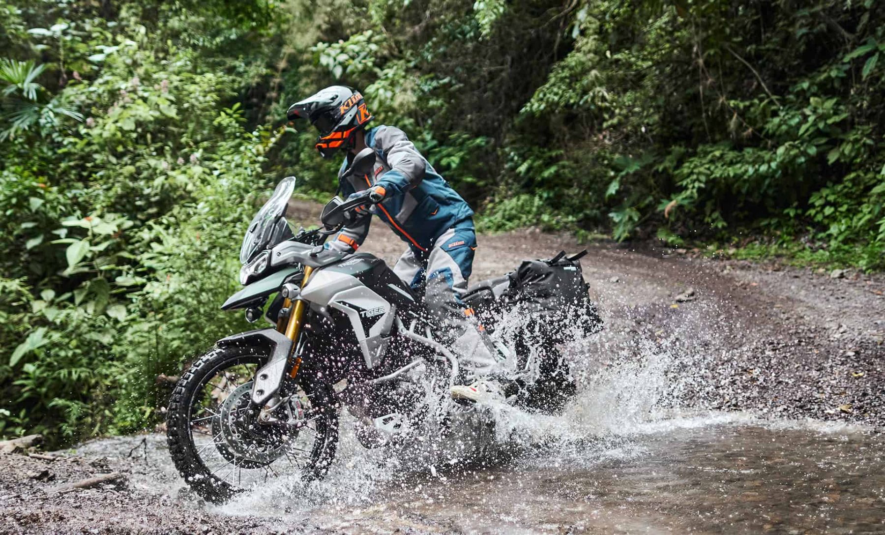 Rider wearing Klim Baja S4 splashing through water crossing
