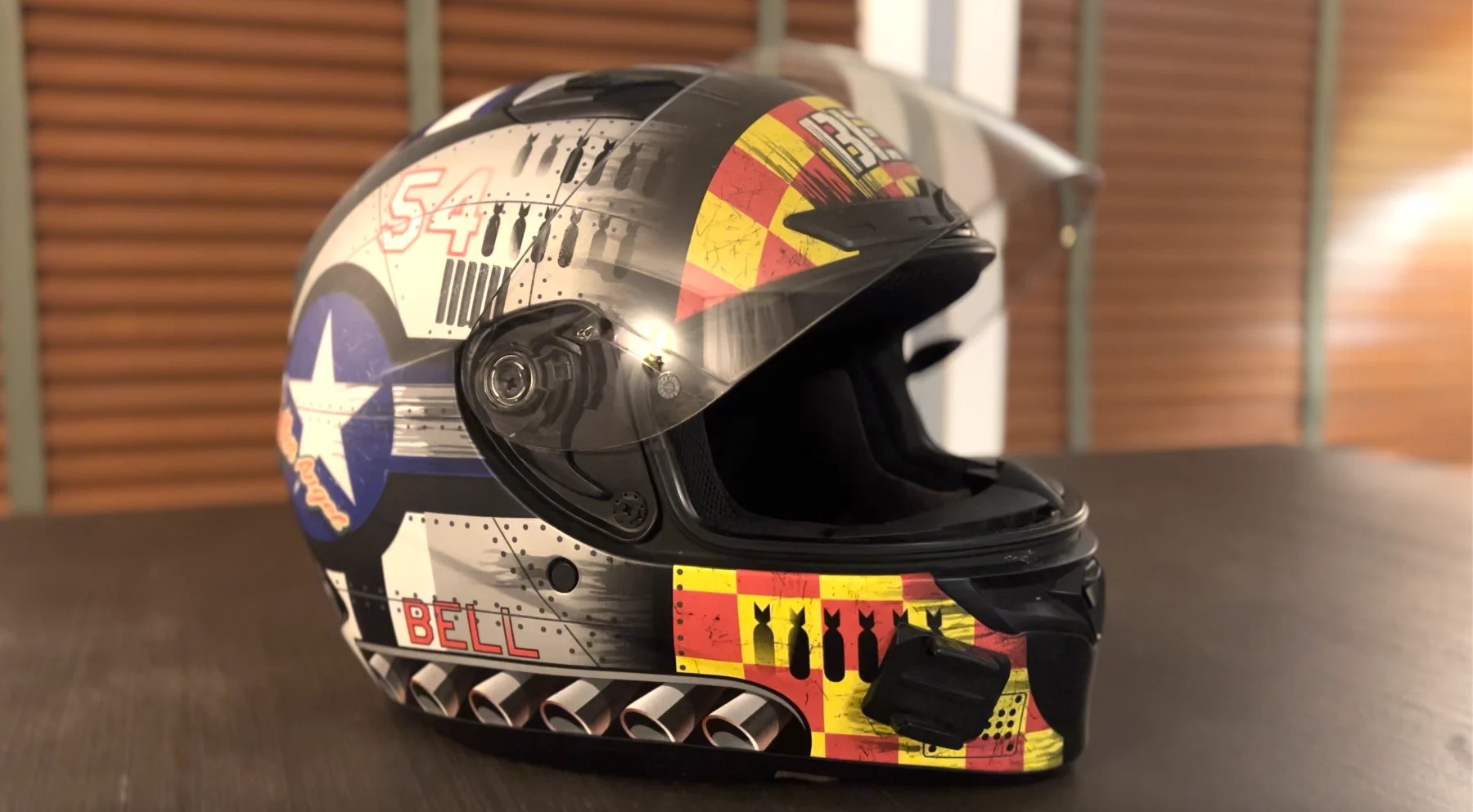 Bell Qualifier DLX MIPS full-face helmet with custom graphic design, featuring clear visor and integrated comms mount.