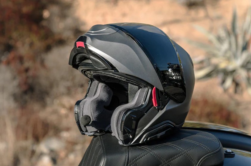 HJC RPHA 91 modular helmet in metallic finish with chin bar open on a motorcycle seat