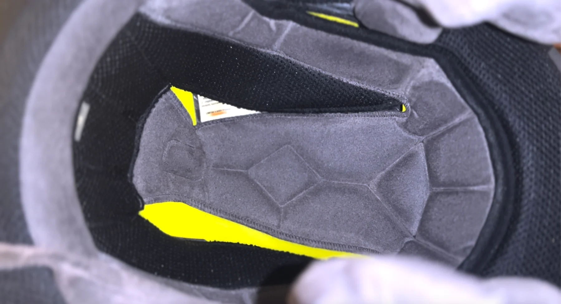 Interior of Bell Qualifier DLX MIPS helmet showing pre-formed speaker pockets for Bluetooth communication units.
