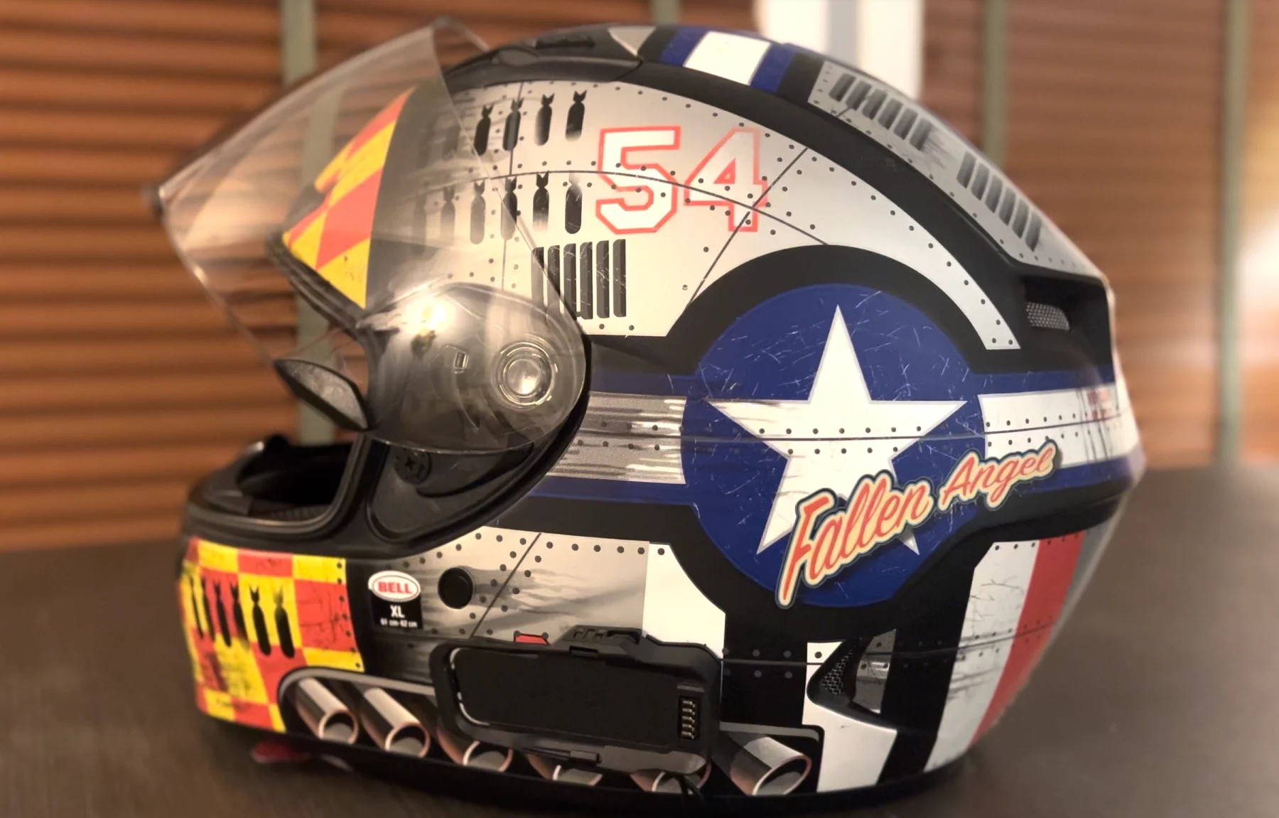 Bell Qualifier DLX MIPS helmet with ProTint photochromic shield, side view showing detailed graphic design.