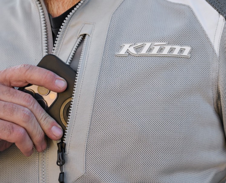 Close-up of Klim Induction Pro jacket chest pocket with phone