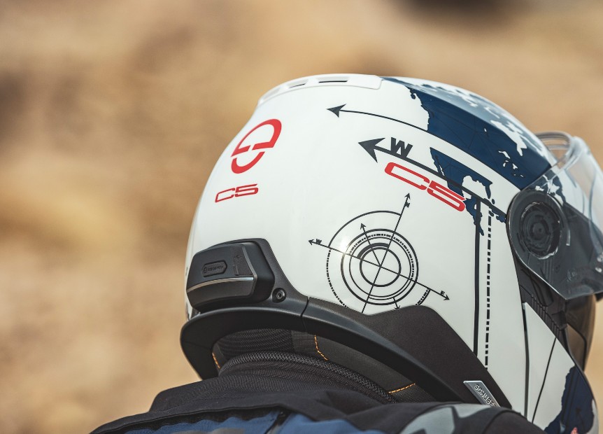 Rear view of Schuberth C5 helmet with integrated comms port and preinstalled speakers, showing world map graphic design.