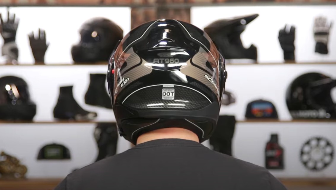 Rear view of ScorpionEXO AT960 helmet showing DOT certification label