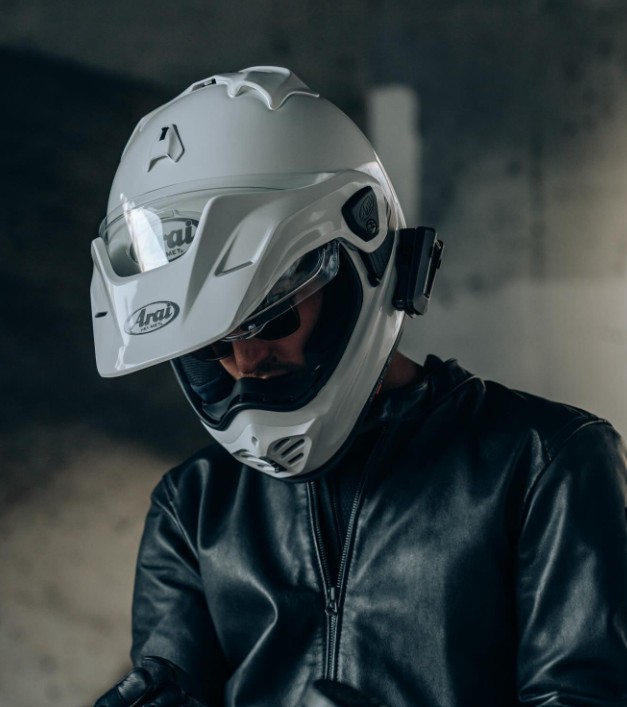Rider wearing an Arai XD-5 helmet with intercom mounted and visor closed