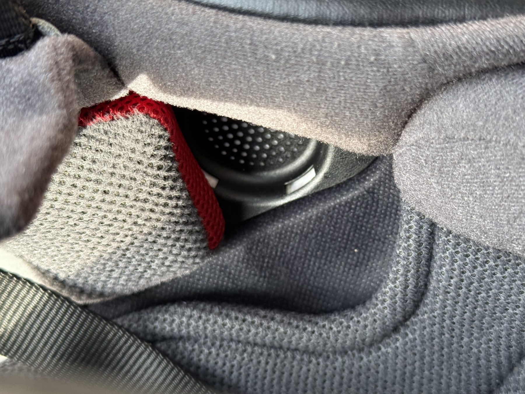 Close-up of Shoei RF-1400 helmet interior showing cheek pad and ear pocket with space for Bluetooth speakers.