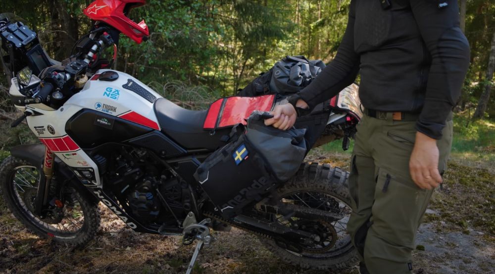 Rider lifting one of the Lone Rider side bags from the motorcycle.