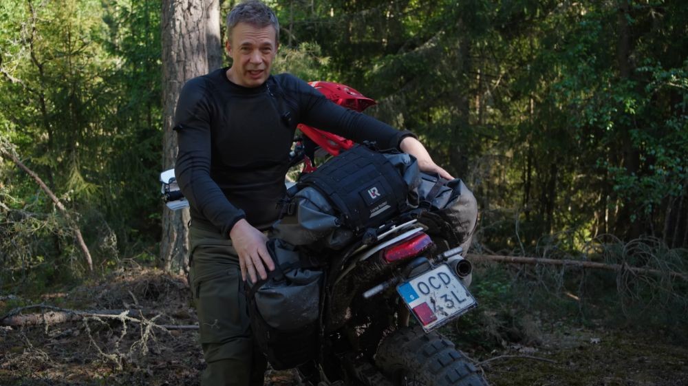 Rider showing the full Lone Rider ADV rackless luggage setup on a trail bike.