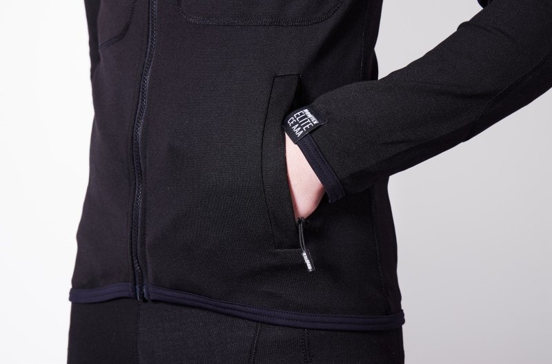 Close-up of Bowtex Elite V2 underlayer shirt showing slim fit with thumb loops and reduced-stretch Dyneema fabric for durability.
