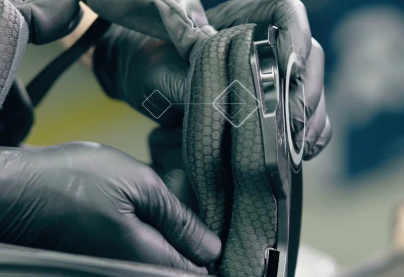 Close-up of HJC i10 helmet cheek pad and liner being inspected, showing interior material and fitment for comfort and comms installation.