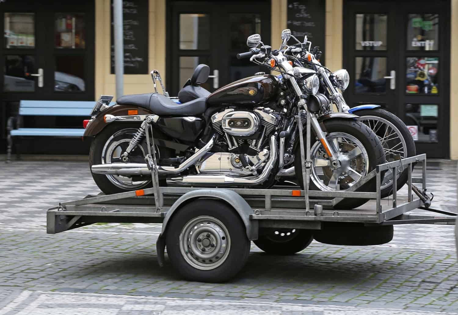 Motorcycle trailer carrying two Harley-Davidson bikes, ready for transport.
