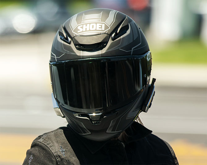 Shoei RF-1400 helmet with a mounted universal comms system on the side.