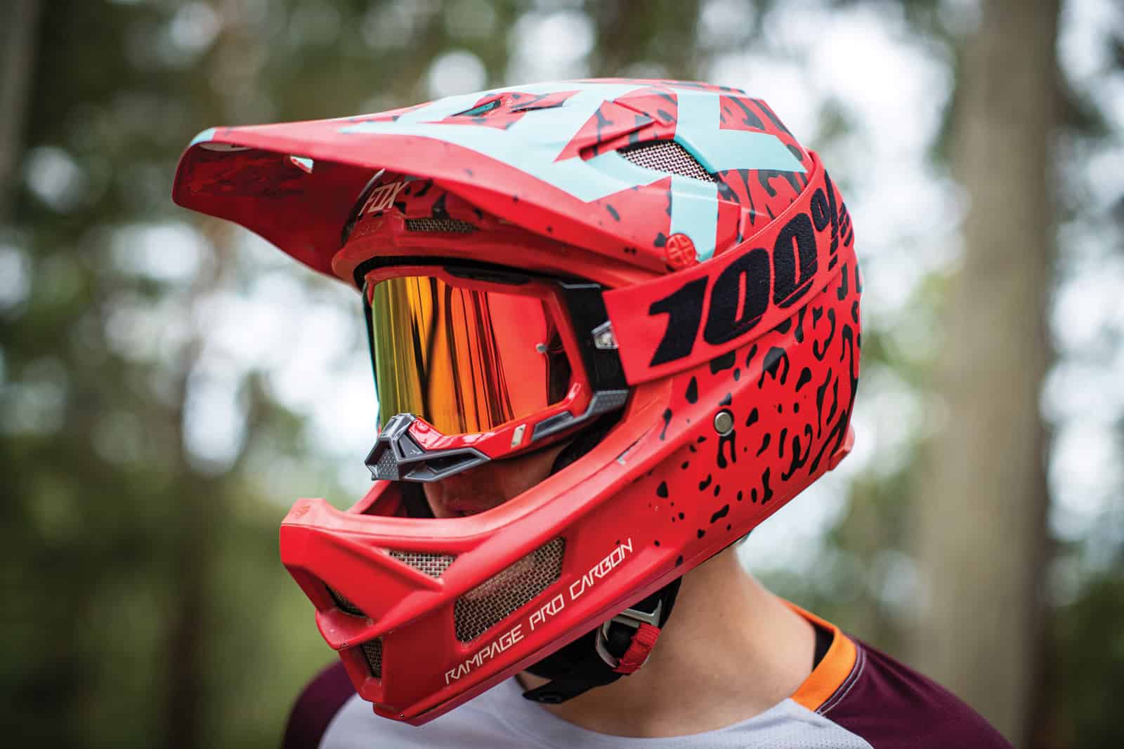 Rider wearing 100% Racecraft 2 motocross goggles with wide strap and nose guard for a secure, comfortable fit