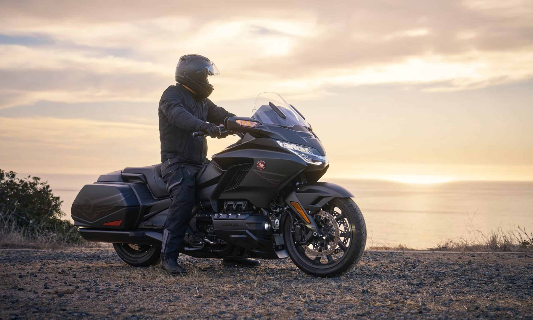 Touring rider on a Honda Gold Wing at sunset, representing durability and smooth performance with Silkolene Comp 4 XP oil
