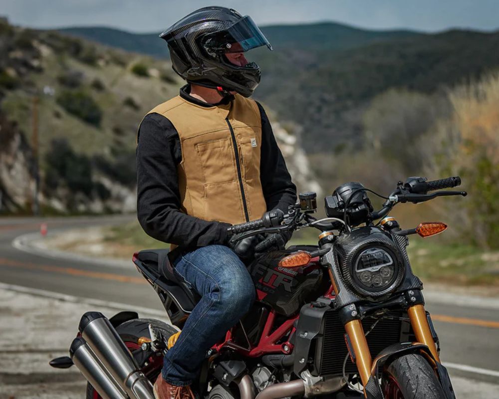 Rider wearing the Alpinestars Tech-Air 3 V2 Canvas Airbag Vest on a modern street bike along a winding mountain road.