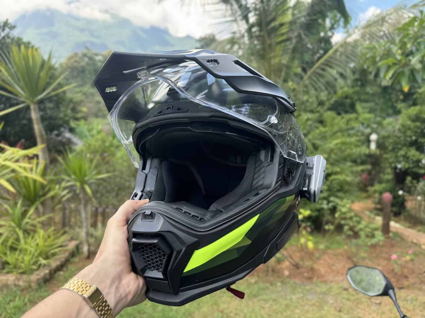 Nexx X.WED3 adventure helmet in hand, showing visor, peak, and ventilation system