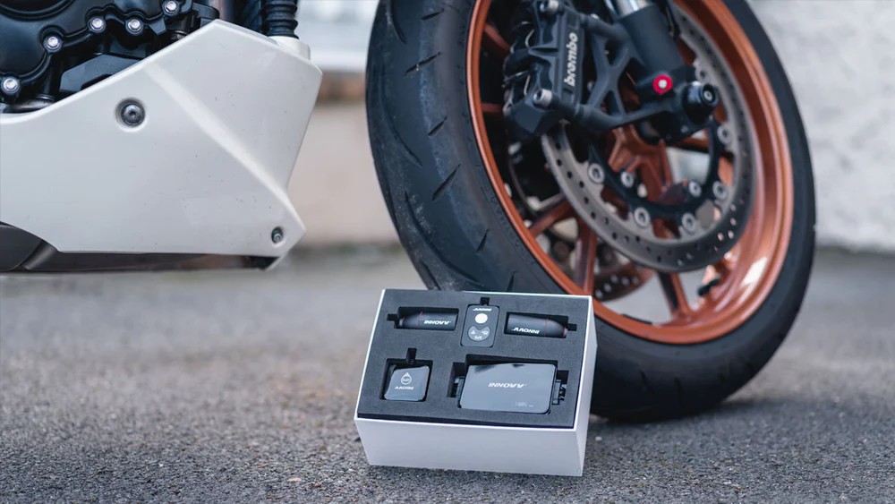 INNOVV K3 dual-camera dash cam kit displayed beside motorcycle wheel