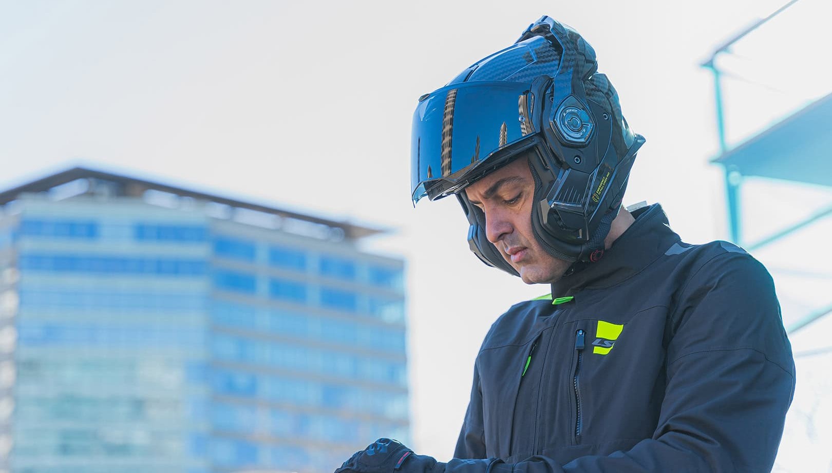 Rider wearing LS2 Advant X Carbon modular helmet with chin bar open