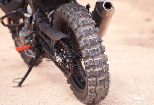 Rear view of Motoz Tractionator RallZ adventure tire with aggressive tread on dirt